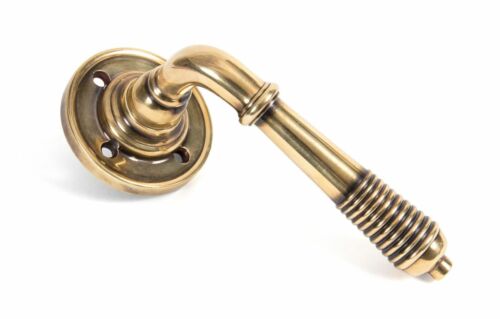 From the Anvil Reeded Lever Door handle on rose Aged Brass unlacquered